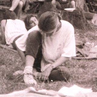 Group picnic in forested area.