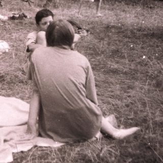 Group picnic in forested area.