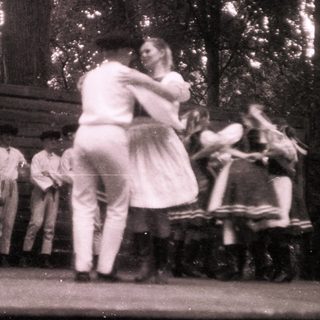 Vintage outdoor dance scene with couples dancing.