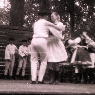 Vintage outdoor dance scene with couples dancing.
