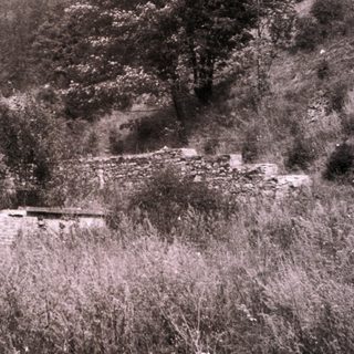 Rural mountainous landscape with old stone structures.