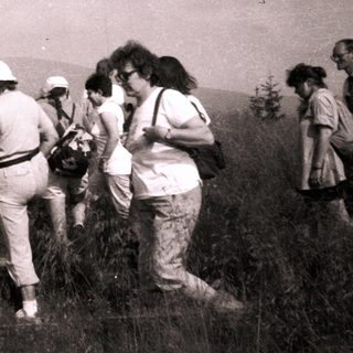 Group hiking in outdoor mountainous terrain.