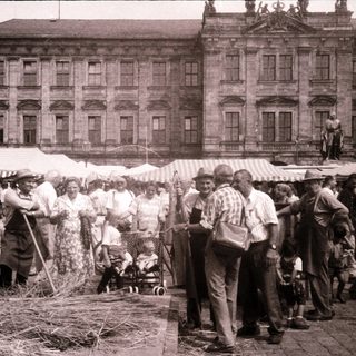 Vintage outdoor market near grand historic building.