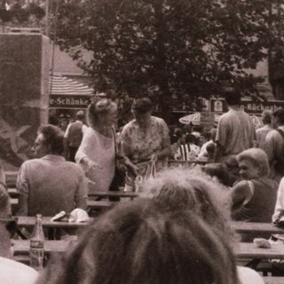 Outdoor festival with live music and crowd.