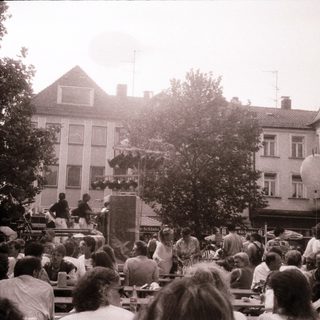 Outdoor festival with live music and crowd.