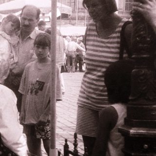 People gathered outdoors at a traditional market or festival.
