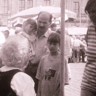People gathered outdoors at a traditional market or festival.