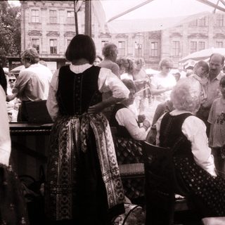 People gathered outdoors at a traditional market or festival.