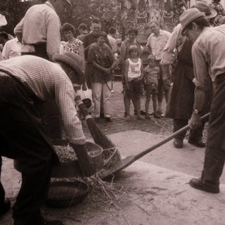Community cleanup around ornate fountain.