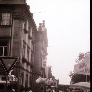 Busy street market scene with foggy urban background.