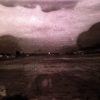 Dark storm clouds over flat landscape.