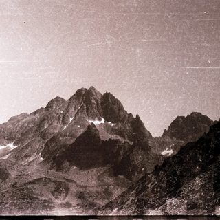 Majestic mountain peaks with snow patches.