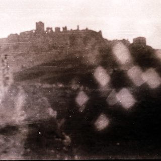 Ruins of a castle on a hillside.