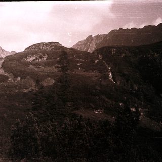 Mountainous landscape with rocky terrain and waterfall.