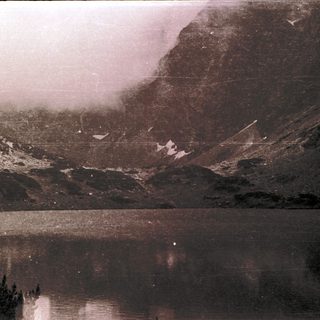 Majestic mountain valley with lake reflection.