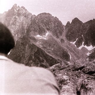 Majestic mountain range with rocky peaks and snow patches.