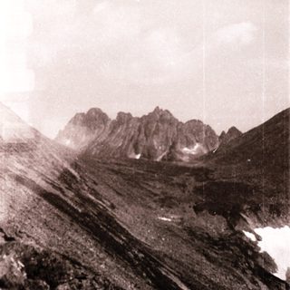 Majestic mountain range with snow patches.