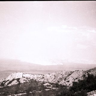 Coastal mountains overlooking distant sea.