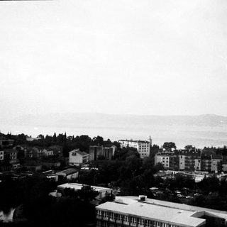Coastal cityscape with buildings and sea view.