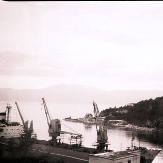 Industrial port with cranes and ships.