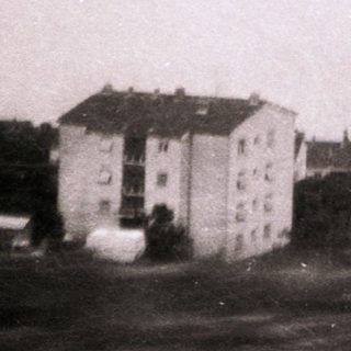 Coastal town with buildings near waterfront.