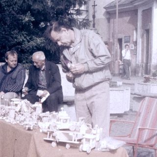 Street market stall selling vintage postcards and small items.