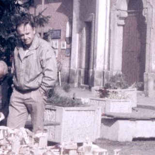 Street market stall selling souvenirs near historic church.