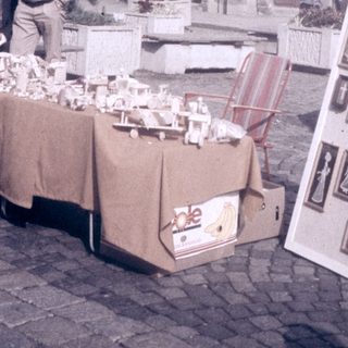 Street market stall selling souvenirs near historic church.