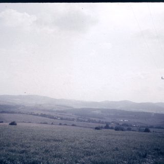 Rural landscape with rolling hills and open fields.