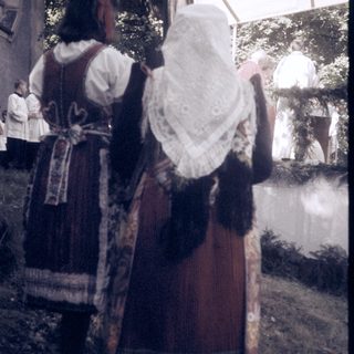 Traditional folk costumes in outdoor setting.