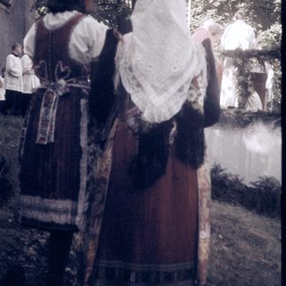 Traditional folk costumes in outdoor setting.