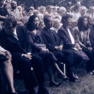 Group of people seated outdoors at an event.