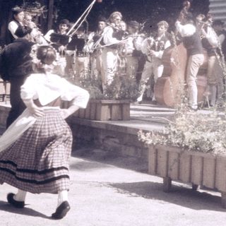 Traditional folk performance with singing and instruments.
