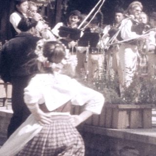 Traditional folk performance with singing and instruments.