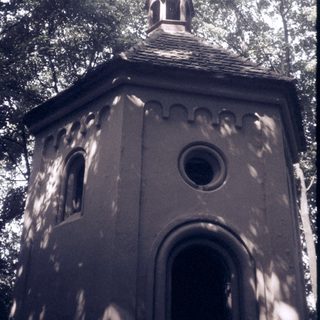 Small stone bell tower with arched windows.
