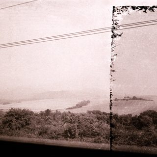 Vintage coastal landscape with distant island.