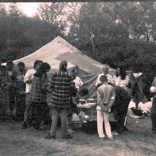 Group camping with outdoor cooking and gathering.