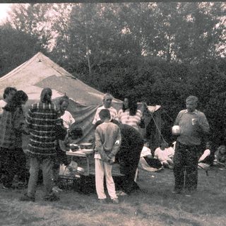 Group camping with outdoor cooking and gathering.