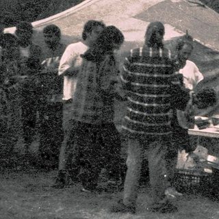 Group camping with outdoor cooking and gathering.