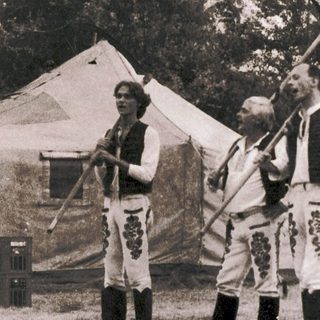 Medieval reenactors demonstrating historical combat techniques outdoors.