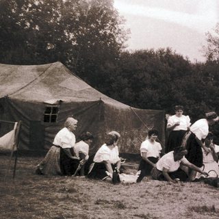 Group playing traditional game outdoors in tents.