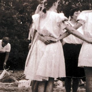 Group of people in outdoor camp setting, engaging in activities.