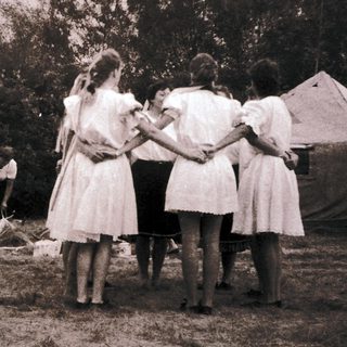 Group of people in outdoor camp setting, engaging in activities.