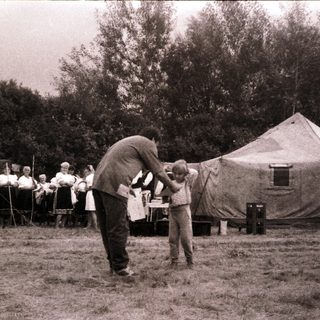 Scouting camp with tents and outdoor activities.