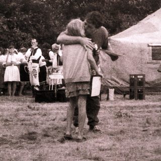 Medieval reenactment gathering with tents and participants.