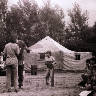 Scouting camp gathering with tents and activities.
