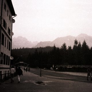 Mountain town street scene with foggy peaks.