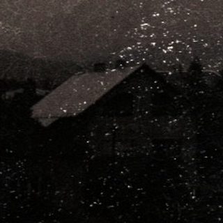 Moonlit landscape with misty mountains and power lines.
