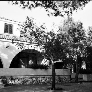 Mediterranean-style building with arched colonnade.