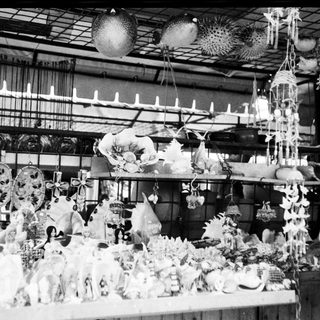 Vintage market stall displaying ceramic and porcelain figurines.
